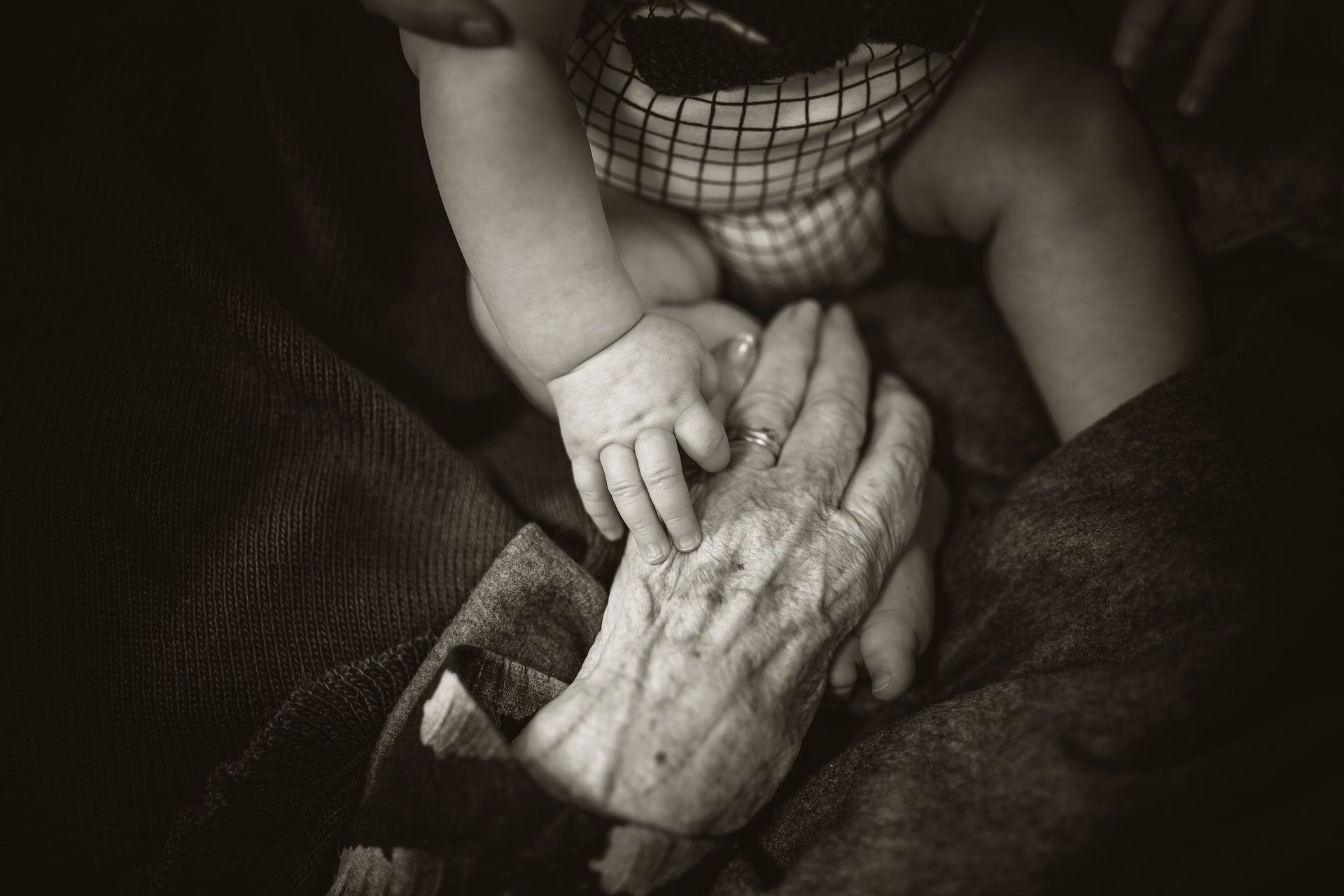 Old and young hands holding