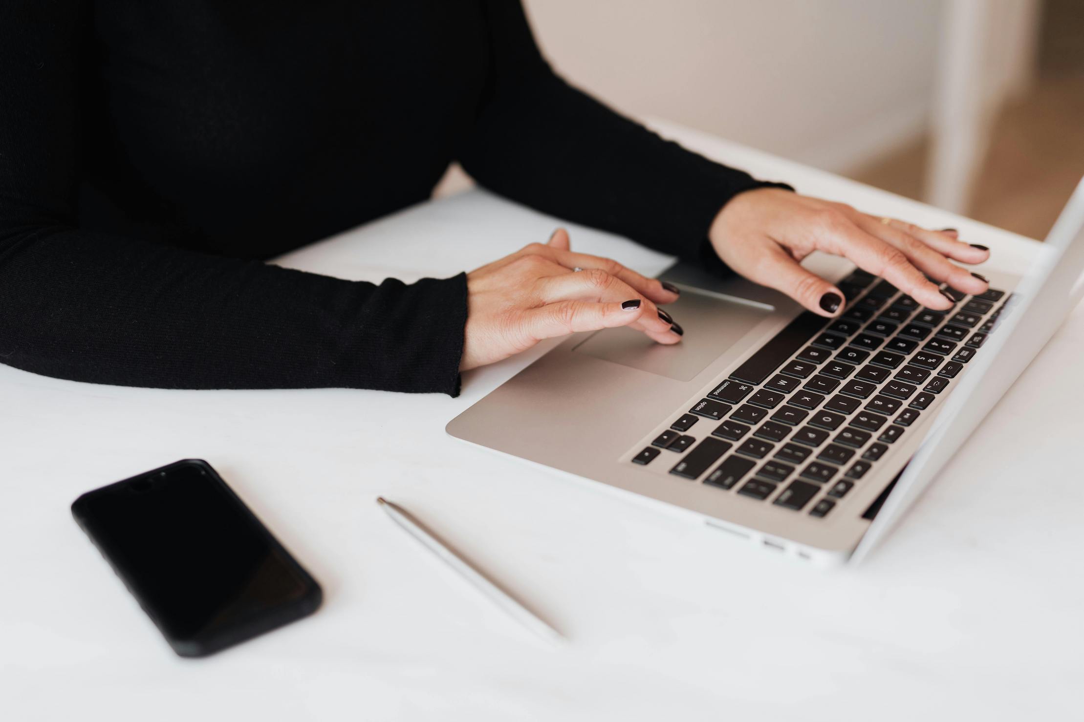 Woman's hands typing on a laptop computer