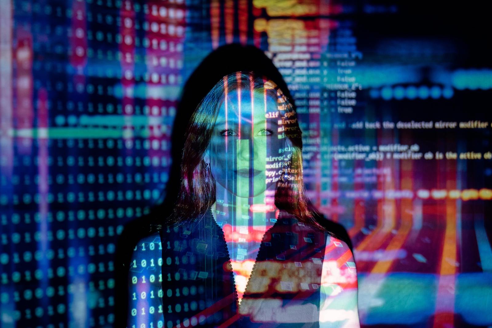 Image of a woman in a black top overlaid by digital code